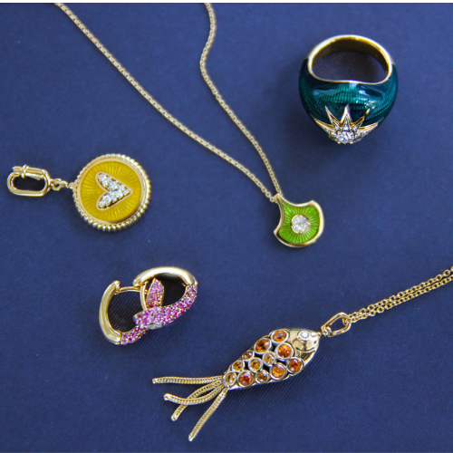 Collection of colorful jewelry including a necklace, ring, and pendants on a blue background