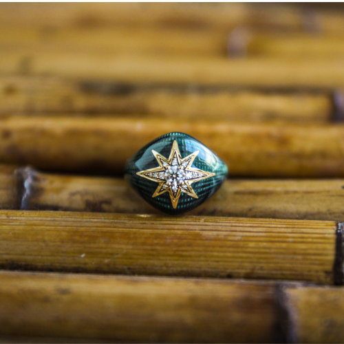 Ring with star design on a wooden surface