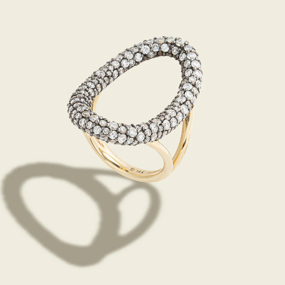 Elegant ring with gemstones on a beige background