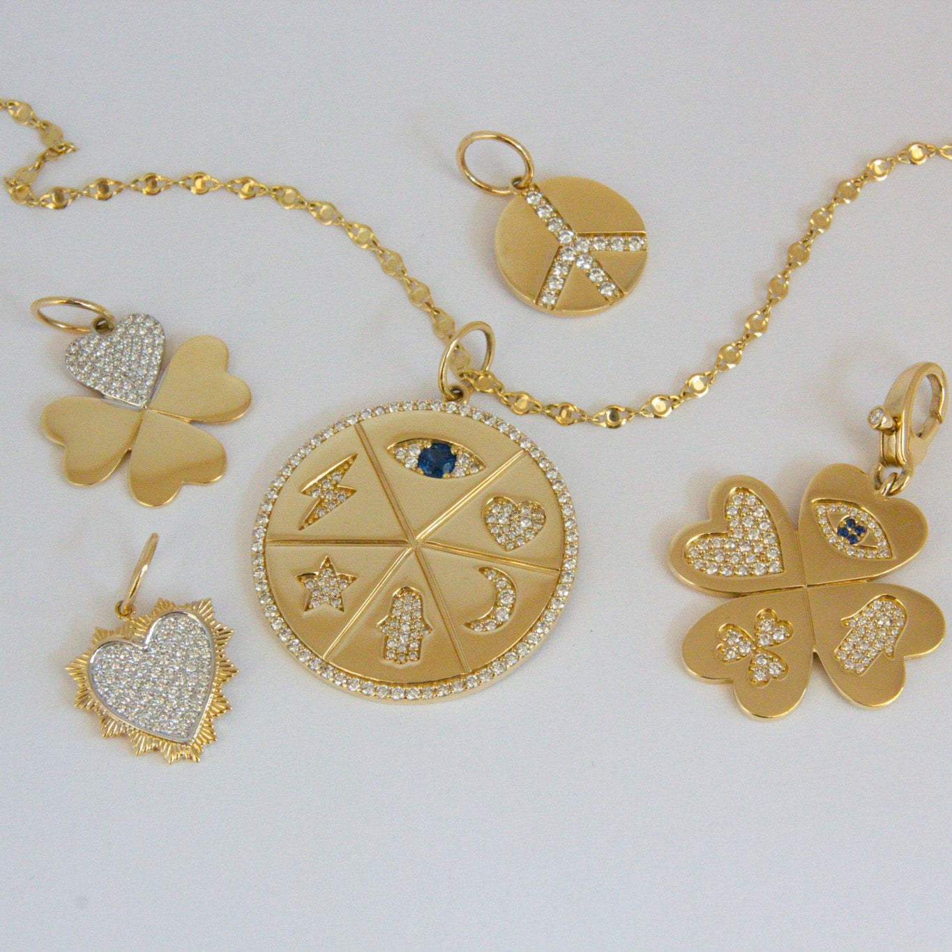 Gold jewelry set with pendants on a white background