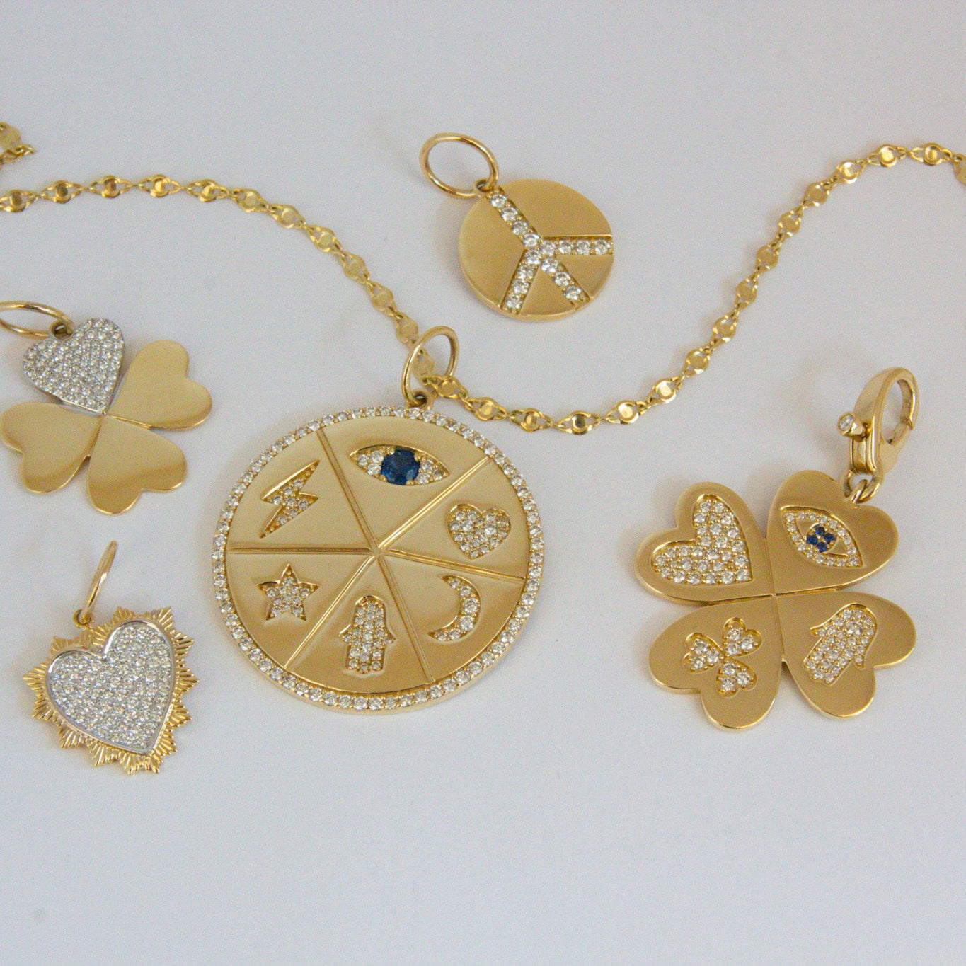 Gold jewelry set with pendants on a white background