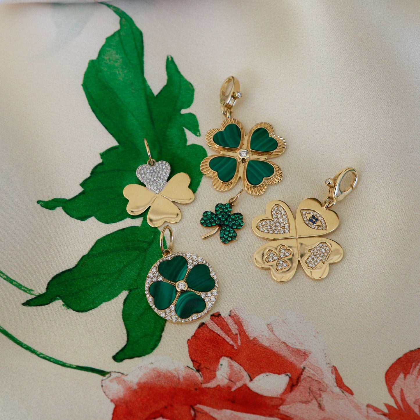Gold and green shamrock-shaped jewelry on a floral background