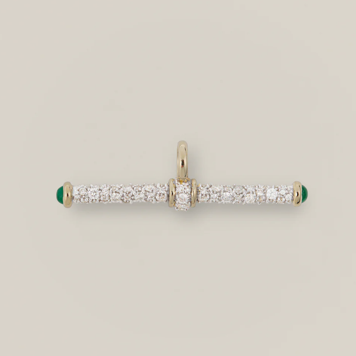 Gold and diamond pendant on a light gray background