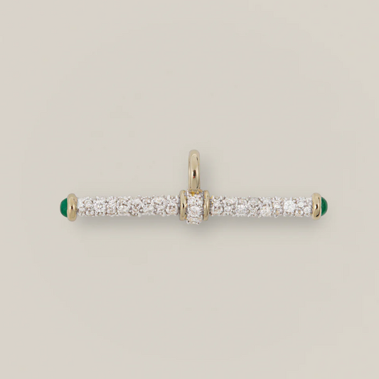 Gold and diamond pendant on a light gray background