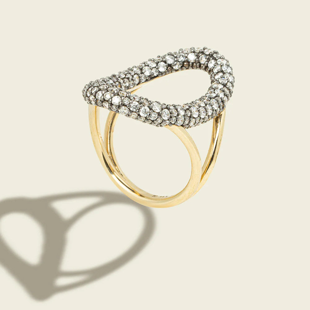 Gold and silver ring on a beige background