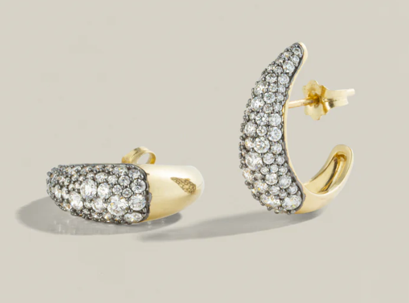 Gold and silver hoop earrings on a light gray background