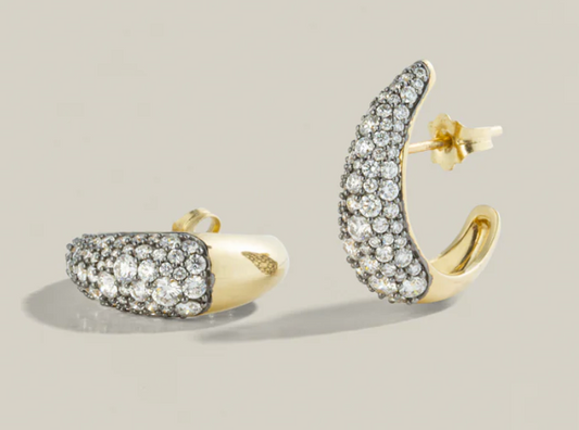 Gold and silver hoop earrings on a light gray background