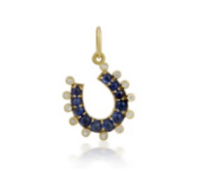 Gold earring with blue gemstones on a white background