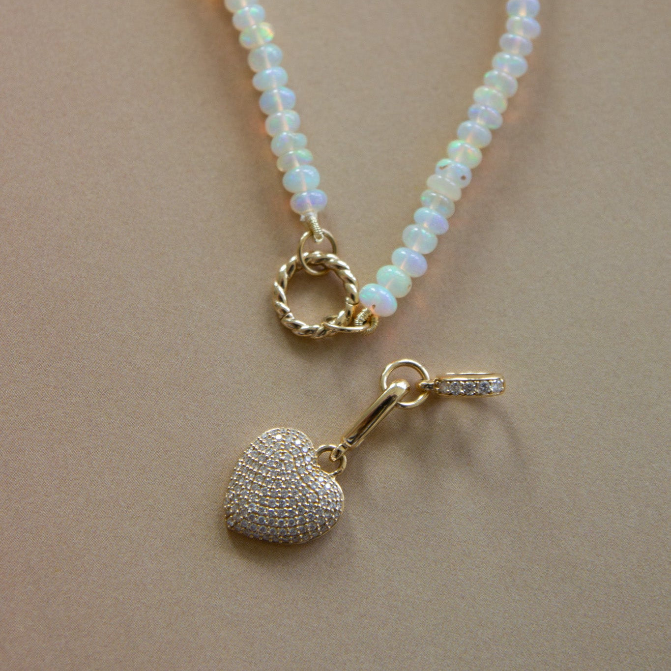 Necklace with heart-shaped pendants on a beige background