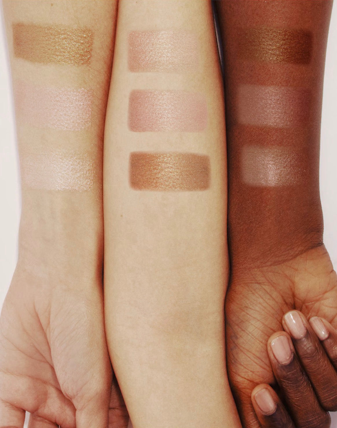 Three swatches of makeup on different skin tones