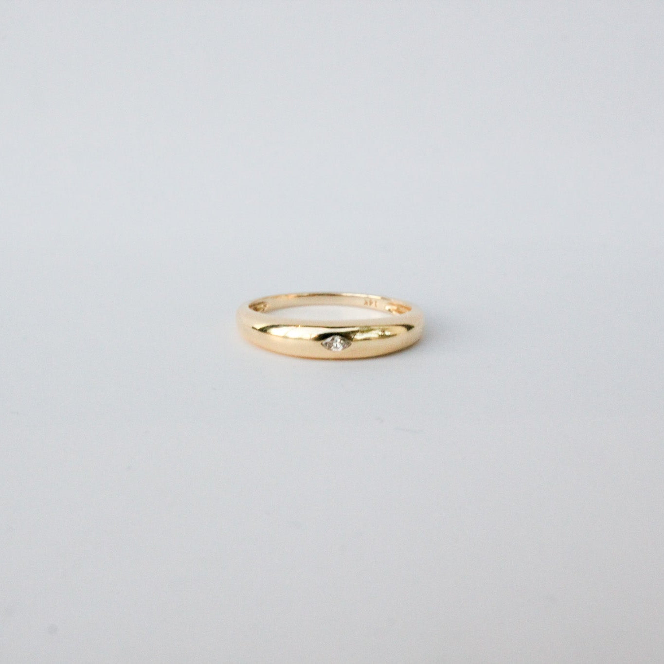 Gold ring on a light gray background