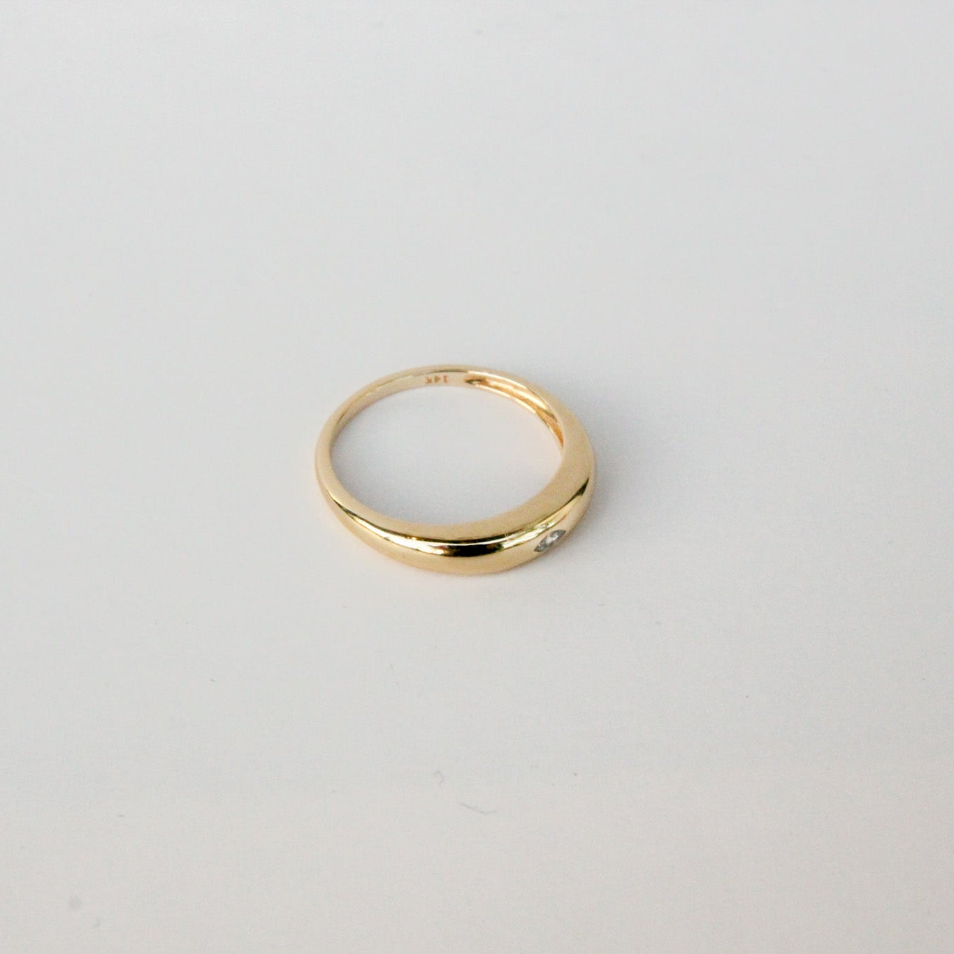 Gold ring on a light gray background