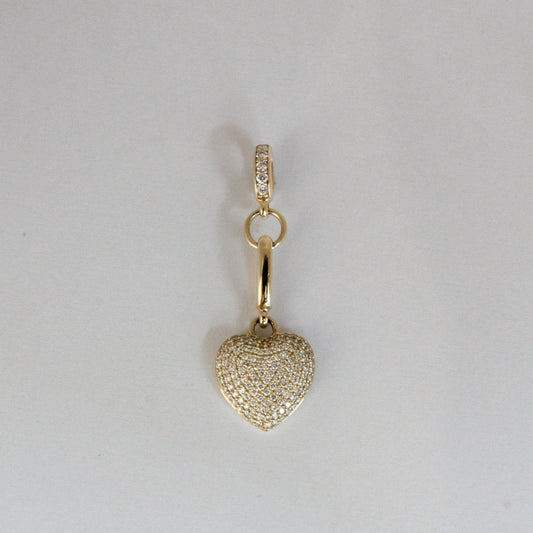 Gold heart-shaped pendant with a chain on a light gray background