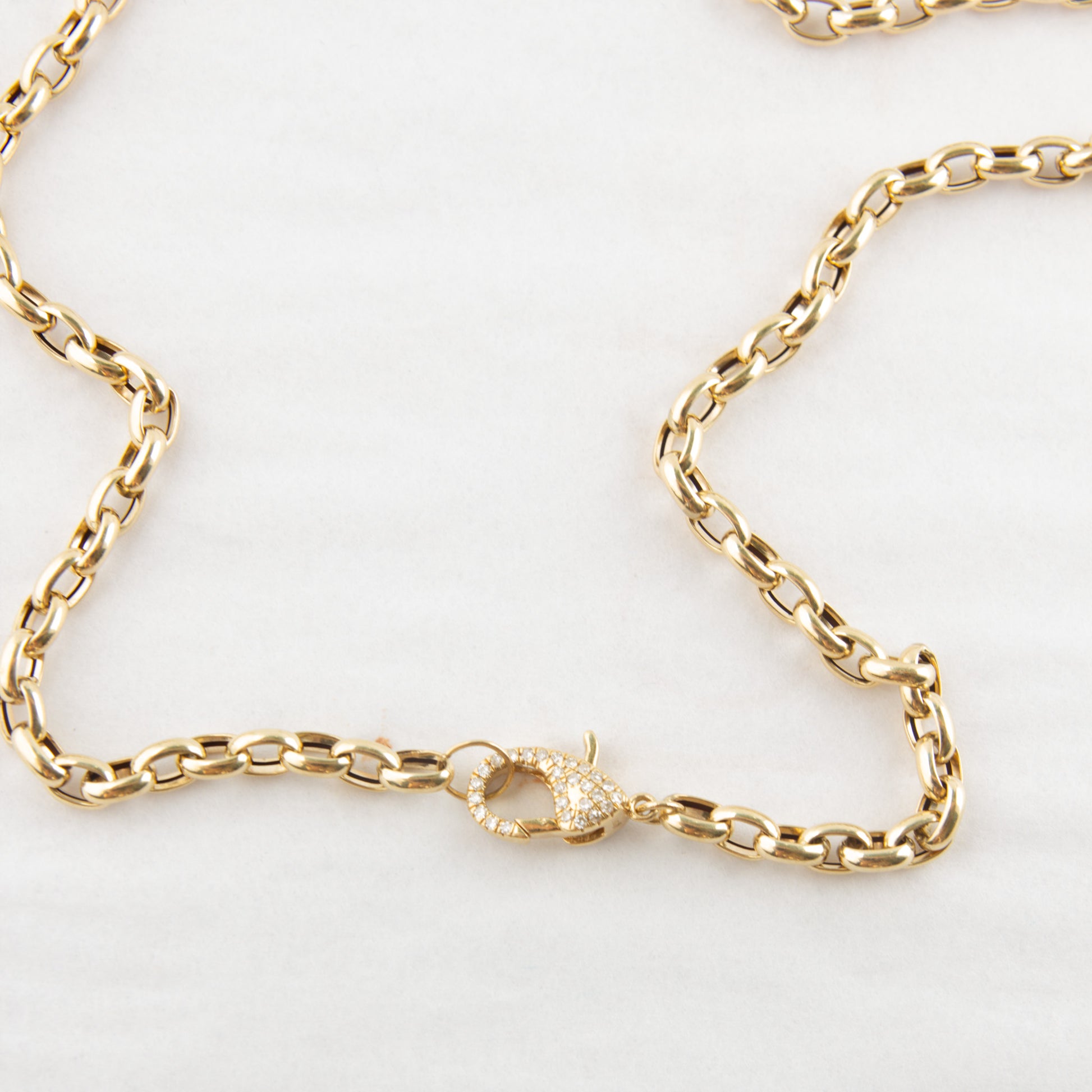 Gold chain bracelet on a white background