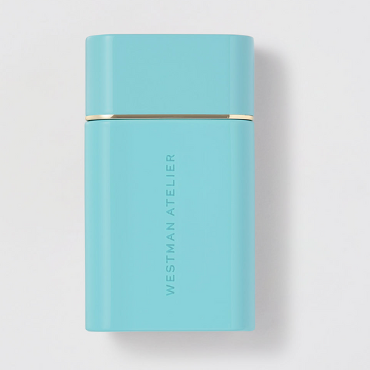 Light blue cylindrical container with 'Westman Atelier' branding on a light gray background