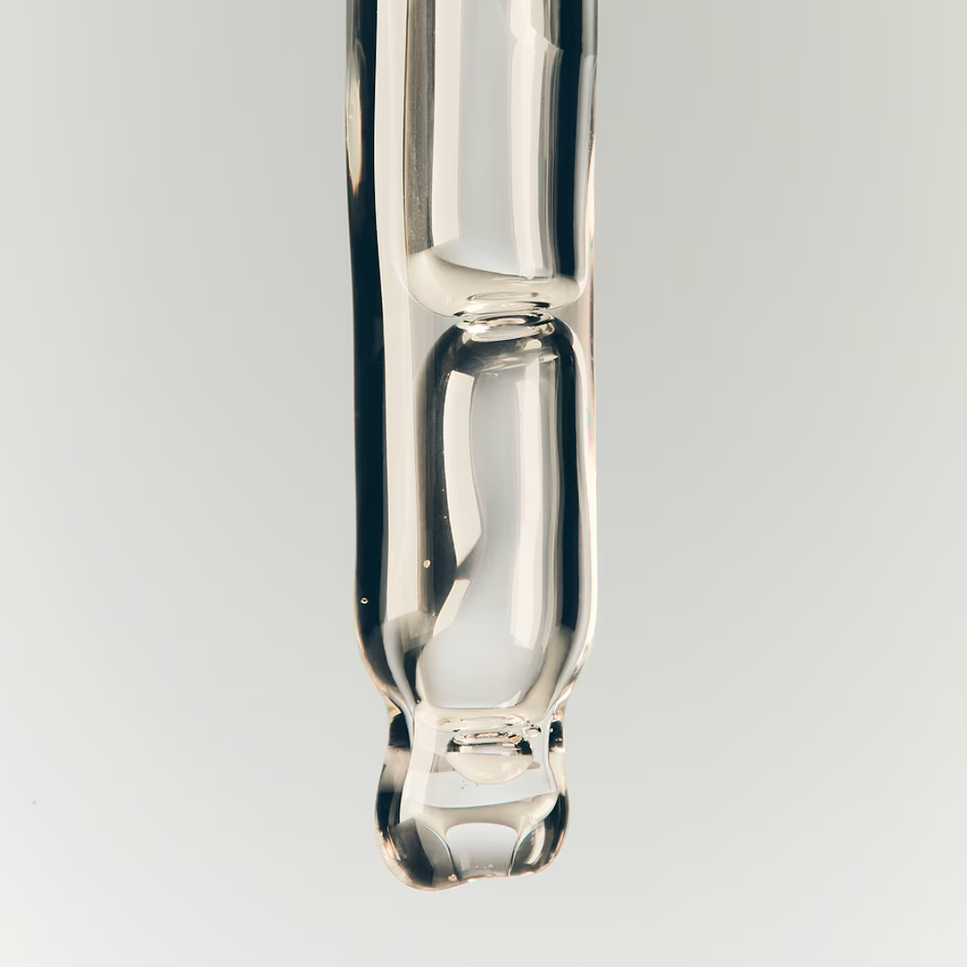Clear glass vape pen on a light gray background